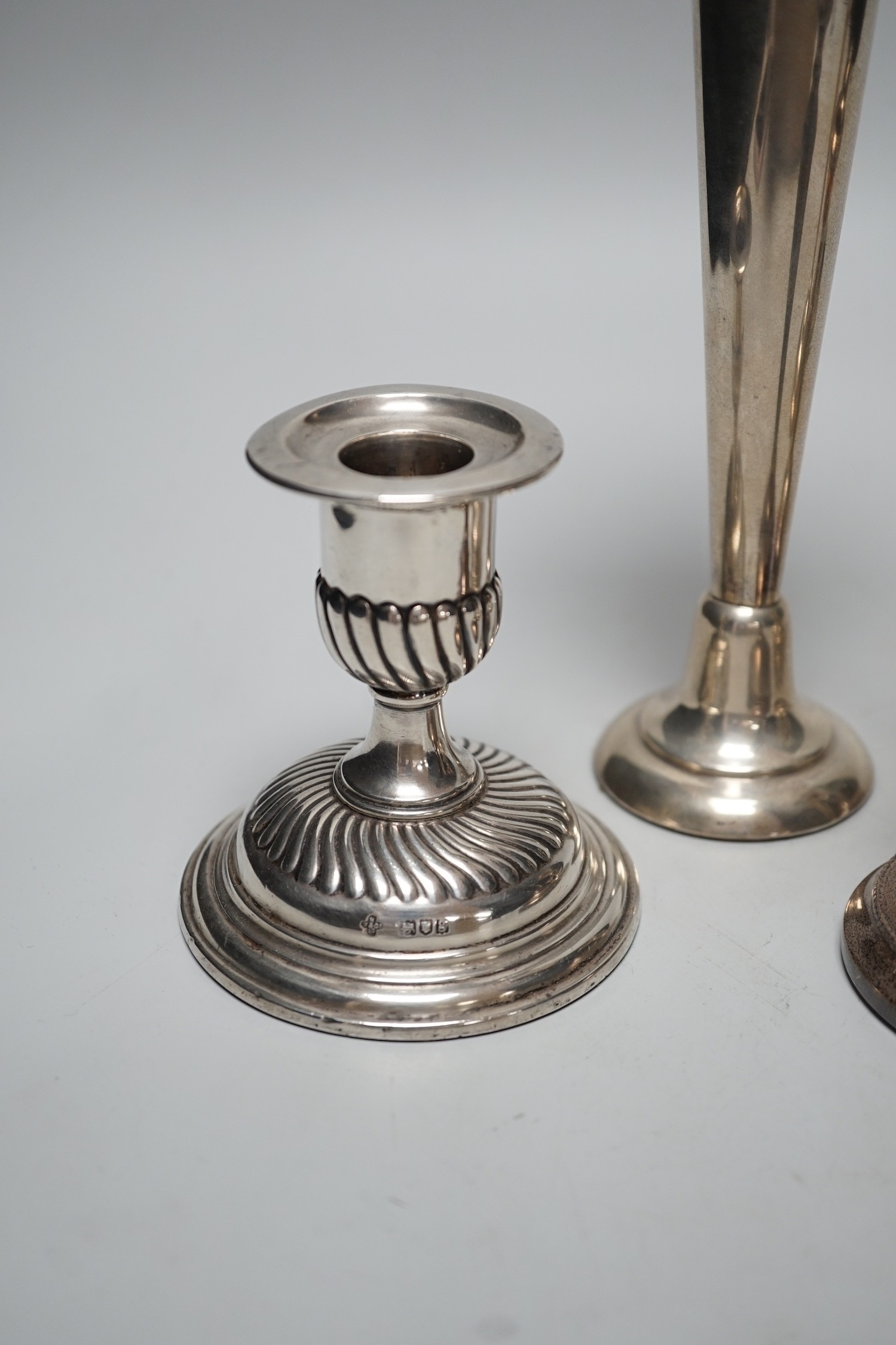 A pair of modern silver mounted candlesticks, 15.4cm, weighted, three other silver mounted dwarf candlesticks and a silver mounted spill vase.